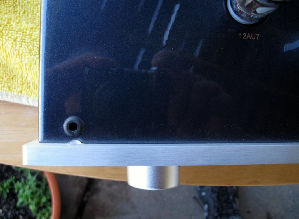 tiny pinprick on top edge of faceplate, near grommet