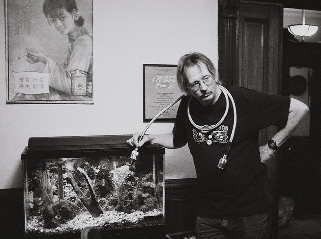 Chris with Fish Tank - Chris is displaying his super power chord to the fish. :)