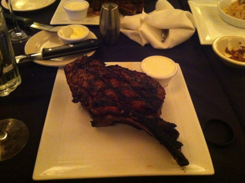 The "Steve Carty" Cowboy Cut - A Big Steak For A Big Man giant bone-in rib eye with grilled red onions and horseradish cream.