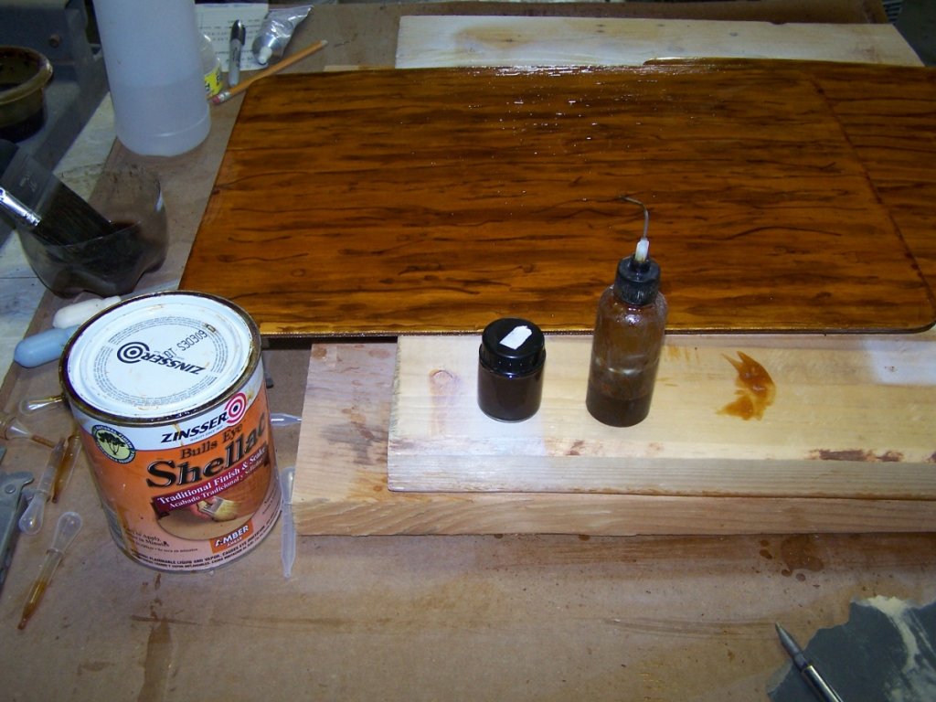 Here is what I used... small vial is brown colorant begged from the local store's paint department. The other goodie is what I used to pump the shellac into the corrugations. Seems it has another use!