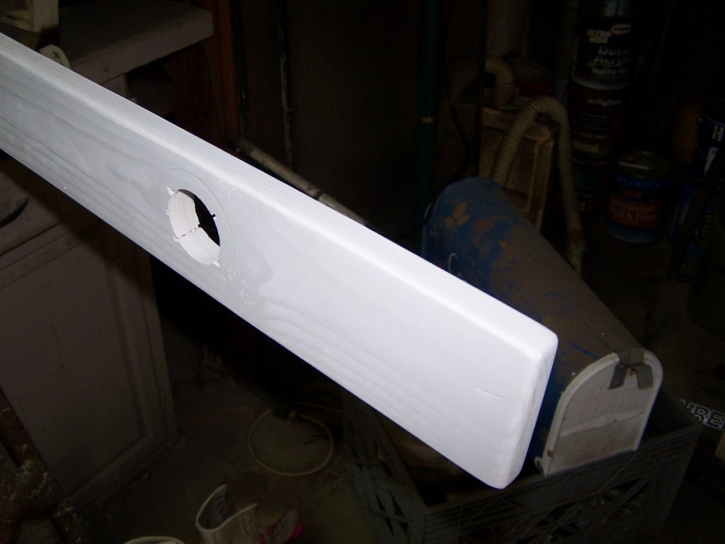 Frame board, corners rounded, sanded and painted to match the back of the panels.
