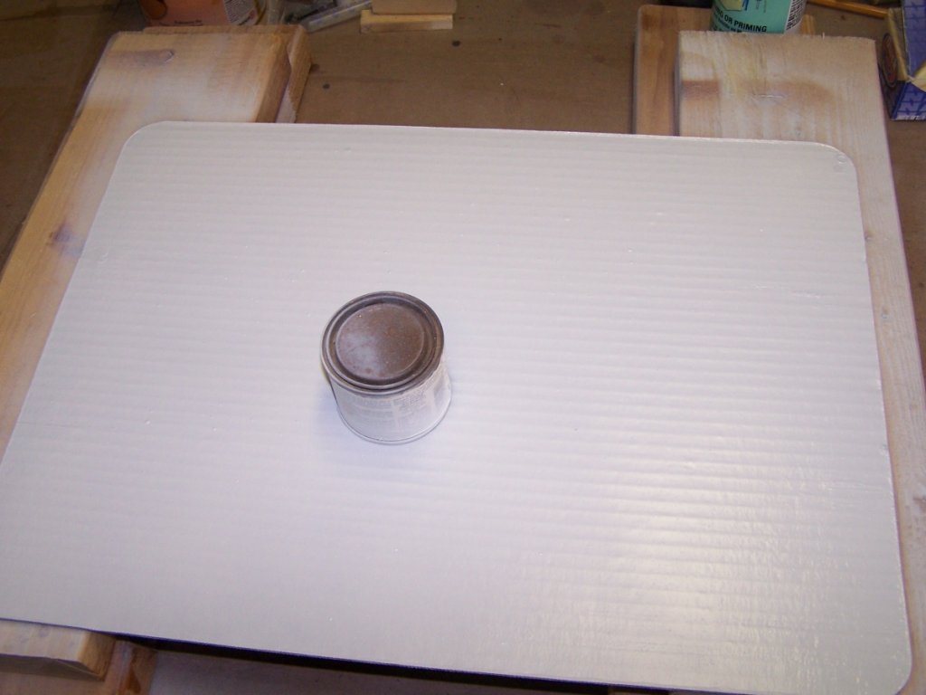 Painting the back of the panel. Can is a mask for the exciter contact area.