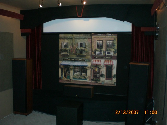 Wall mural behind screen - Big black wall made better looking! Just something to break the black, bare wall when the screen is retracted....also reflects a little light into the room for general purpose