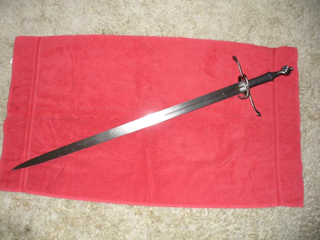 A German Bastard Sword - This weapon falls under the classification of the Longsword. It dates back to around 1600. It can be used with a single hand, or two. The second hand is generally held just behind the first to aid in steering and control. It is not there due to the weapon being heavy. Most real swords are quite light, ranging from 1.5 to 3 lbs. This one may weigh 2.5 lbs at the most.