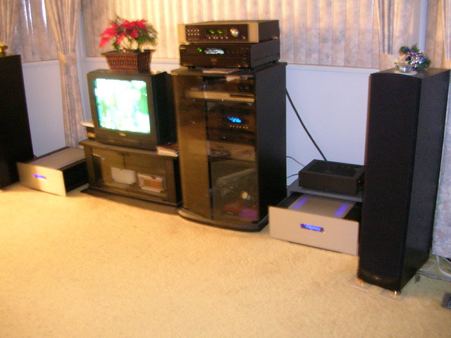 Full system - Shows cmplete system consisting of: 
Power amps: Odyssey Audio Extreme Mono S.E.'s 
Pre-amp: Sonic Frontiers Line2 SE 
Source #1: Sony SCD333ES SACD/CD player under pre-amp
Source #2: Toshiba DVD3650 DVD player 1st item in rack
Source #3 (and my favourite): Cary CD308 2nd item in rack
4th item is HI-FI VCR
Our huge 21" TV with another HI-FI VCR below it.