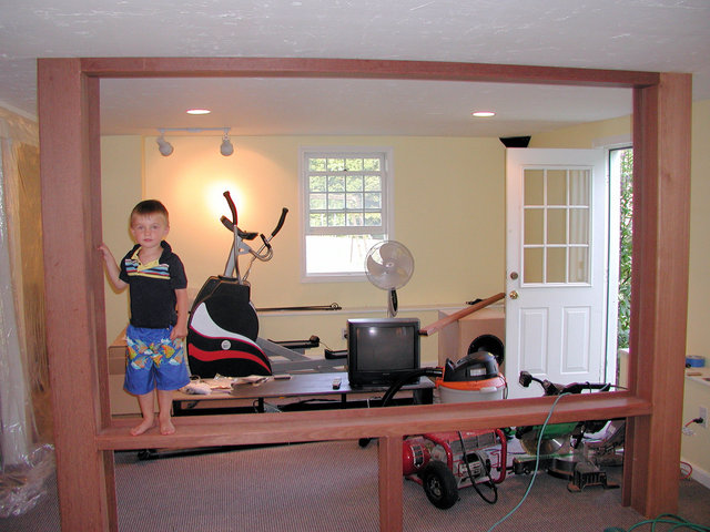 most of the mahogany trim is installed - my son standing near the left column