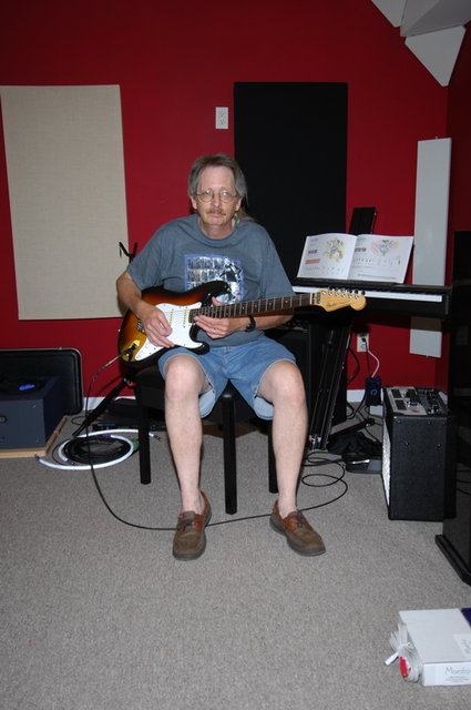 Chris in the basement playing the guitar