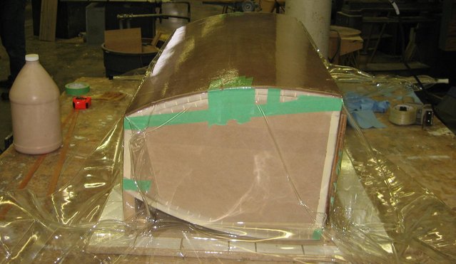 Veneer press - Speaker cabinet in a vacuum bag. A sled built to keep things from rocking back and forth lies underneath.