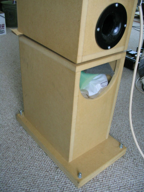 Stands 2 - They are made of 3/4" mdf, with an extra long double thickness piece serving as the base, which also has DIY spikes ground from machine screws. The semi-circular hole allows for filling with bags of sand, with some odd bits of foam topping it off (cavity elimination). The stands weigh ~ 80 lbs