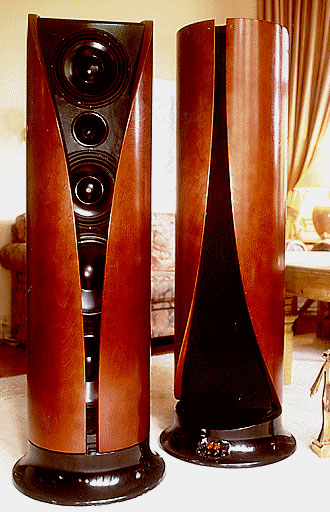This is a horn speaker. - But a different breed of horn speaker indeed.
It's a "Vertical Split" horn speaker called VSS Ultima.
It's also a horn speaker with no cabinet...sort of
It goes down to 20hz and sounds like thunder and silence in a mix!
It's got the impulse response sort of like that of a 'stat; immensely fast..
10 degrees phase error (actually less!) from 20hz to 30khz 
and -1db, 1.5db frequency deviation.
Crazy specs, that is sure.
It'll take 1000w of amp power and live to tell about it. 91db efficient.
Yes... it's from Norway. No, it's not a viking style totem pole!!! It's a Forsman VSS!
Yeah, and it uses driver earthing, like Tannoy uses. 
I've heard a demo with this type of mods and it clearly works this type of earth-thingie stuff..
what ever. It works!