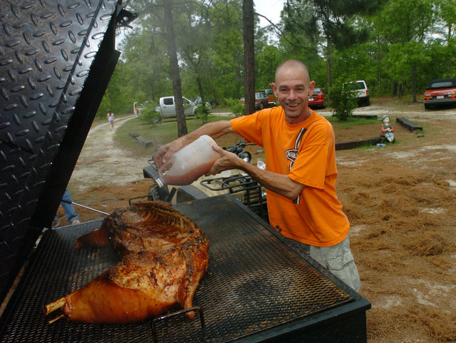 Ed slathers the pig with vinegar - The food was awesome,great BBQ! at Horn Fest 2008