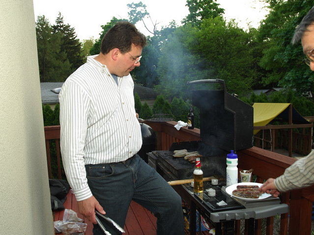Mike grilling sausages