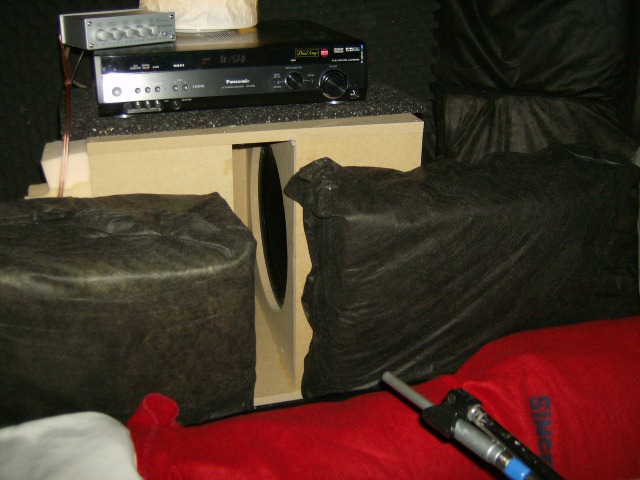 The sub is placed just behind the listening position, at ear level. - The red part is a blanket that covers the sofa. I temporally placed two pieces of rockwool between the sub and the back of the sofa in order to decrease reflections from the hard surfaces.