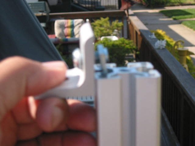 Sliding inside corner bracket / T-nut assembly into T slot.