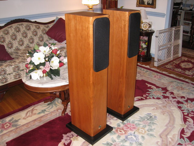 GR Research AV-3 TL Tower Speakers - Front left view with grills in place.Natural cherry finish