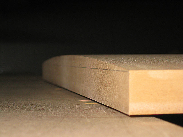 IMG 0250.JPG - It produced a beautiful 9 ft. radius curve. The material is 1â…›" MDF. I removed about 1mm from the apex and that left a Â¾" edge.