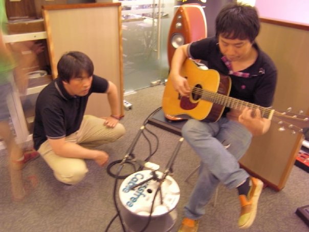 Ken-san squats besides Mitsuru to monitor the application of each Acoustic Revive tweak