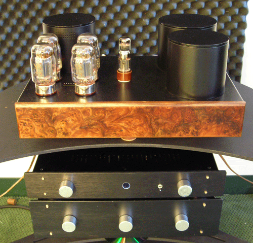 Reference JD801 - Here is a quick shot of a Reference Jolida 801 that has been in use in the showroom for several years now. The face is 1/2" Elm Burl and the transformer cover top plates have been sprayed with satin black epoxy.

Below the amp are two early prototype Musica Bella Purity preamps. The bottom piece is still in use in our showrrom while the top unit is in use in an Audio Circle member's system