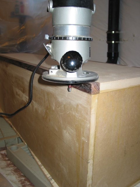 Flush trimming the 1/8" overhand of the hardwood trim flush to the sides of the speaker
