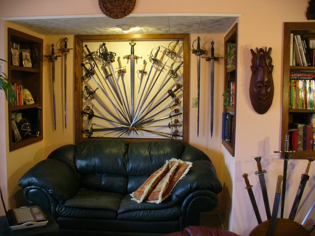 The Armory - Well, actually our TV room as of 2/22/09. This is a partial collection of the historic edged weapons that I own and train with. There is a mix here of authentic antiques dating back to around 1600, museum quality replicas, and pure training weapons.