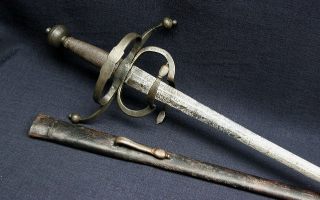 French Rapier - It has French inscriptions and more than likely is either Italian, or German made around 1625. What is very unusual is the complete leather over wood scabbord which are rarely seen for a rapier such as this.