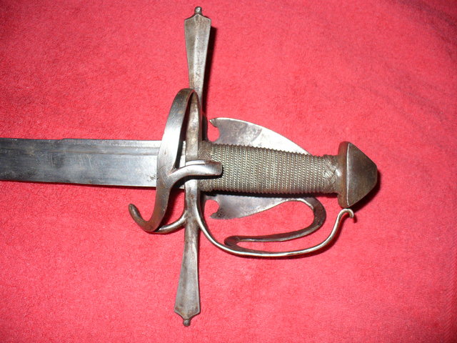 Tessack - This is a very early (late 1500s - 1610) cutlass used in the Northern European wars. This hilt is also sometimes called the Sinclair hilt after the famous Scottish mercinary that favored this weapon in these wars. It is thought that the famous Scottish basket hilts are a decendent of this design influence.