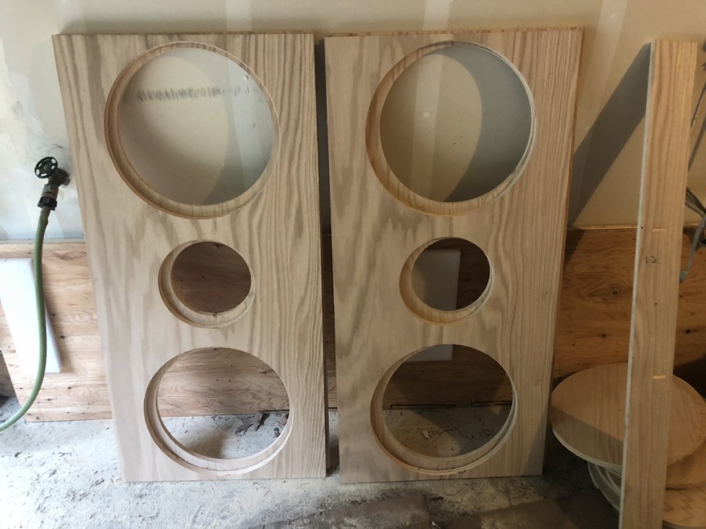 All four baffle pieces cut and standing together. The plan was to double the stock material thickness by laminating two pieces together. Woofers recessed in the back, full range surface mount from the front.