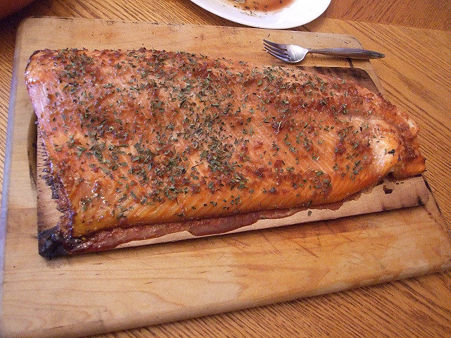 Salmon sits on cedar plank, screaming...eat me eat me.