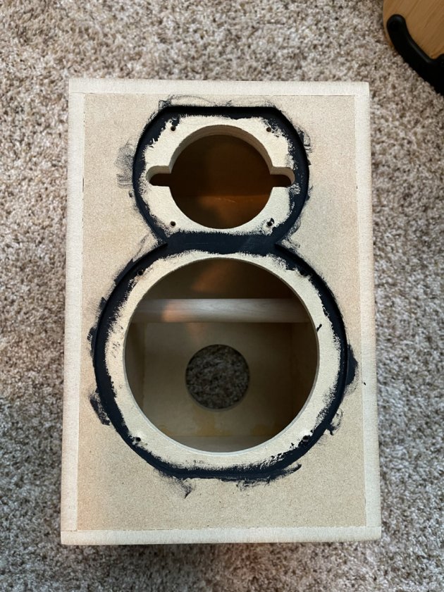 After test fitting the veneered box I noticed that the MDF could be seen around the drivers. So I painted black around the edge to hide it. Much easier to do this before putting the veneer on.
