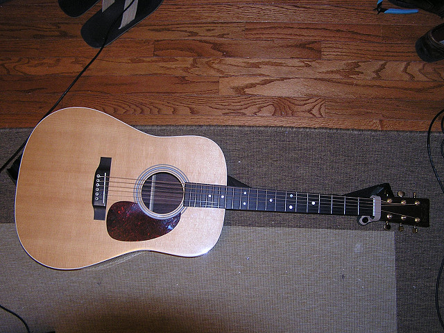 Martin MMV dreadnaught

Solid Sitka spruce top
Solid East Indian rosewood back & sides
Nitro-cellulose gloss finish
Mahogany neck, ebony fingerboard
Gold tuners
Deluxe 19-ply rosette
White binding
Dreadnought body
X-bracing
My upgrades: 
Bone bridge pins
Fossilized walrus ivory saddle