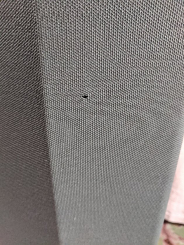 Very small hole on front of one of the speaker cloth.