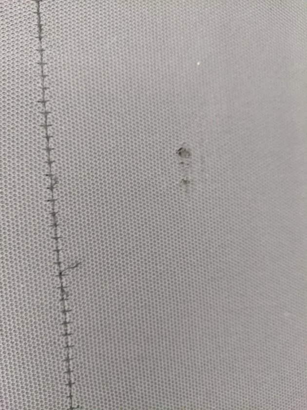 Hole in cloth on back of other speaker