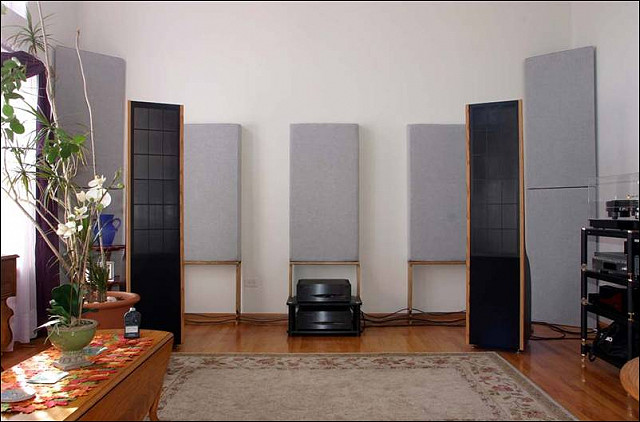 Two channel room with Inner Sound Eros MK III ESL speakers. Four GIK Tri Traps stacked in corners, three GIK 244 panels on back wall with DIY stands.