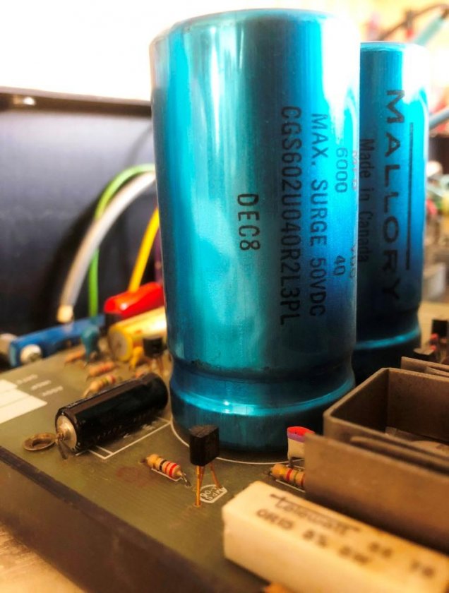 Figure 2: Original power supply capacitors, 6000 uF / 40 VDC - cartridge fuse is on circuit board's right-hand side.