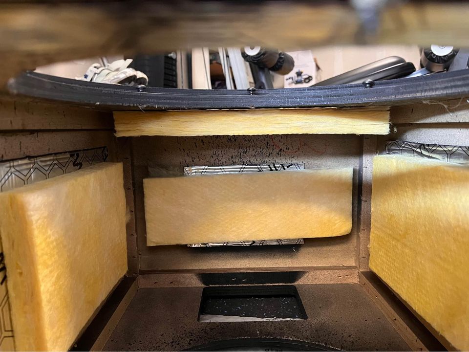 Internal dampening, dynamite like on the cabinet topped with 1" Fiberglass Board.