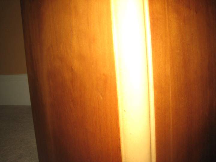 small blemish about 10 inches from the bottom on left side panel of speaker (B)