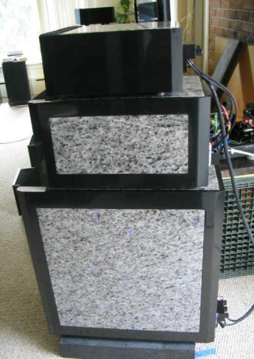 The mid and tweeter module wiegh 75 and 50 lbs respectively, and are suspended on downward facing Stillpoints. Each Stillpoint rests on a 1