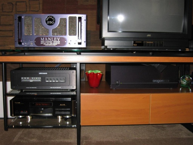 Bello' rack has cantilevered shelves, tinted glass, cherry wood and is quite sturdy