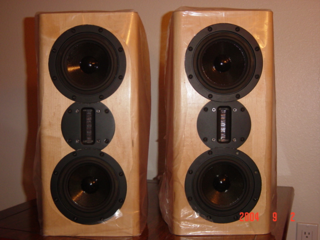 Don't laugh but I never took the clear plastic wraps off the speakers. I was anticipating a change of residence, so I kept the wrap on the speakers to prevent scratches from the transit. Holes were cut in front of the drivers, ports, posts.