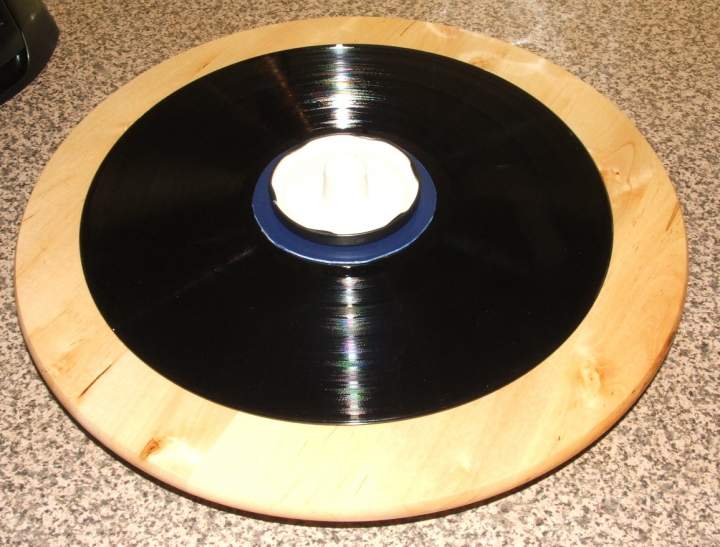 Record retained by combo of plastic disc, jam jar lid and door stop