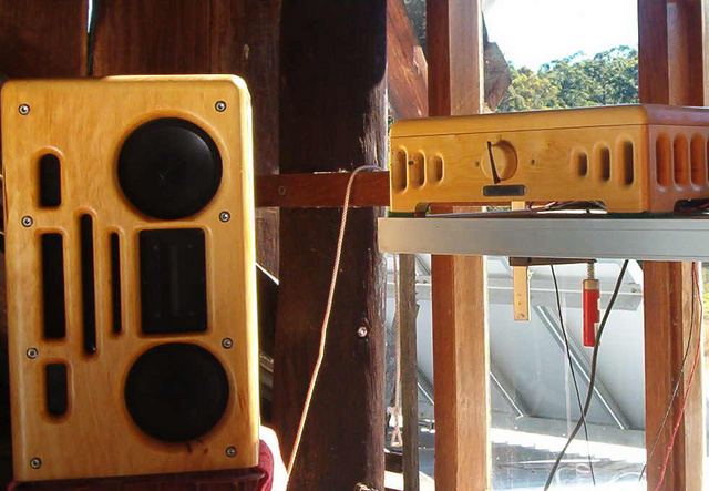 speaker & amp with power source, solar panels in the background.
