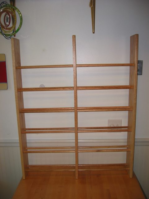 Width is 34 inches, and single dowels run the entire width. Dowel sagging necessitated the middle vertical support. Height of vertical pieces is 42 inches.