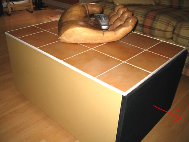 This is my DIY Subwoofer project. It has a 12 dual voice coil operated by my front stereo amplifier. It also doubles as a coffee table. The tiles get a high WAF