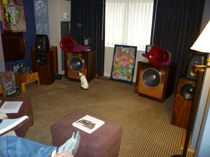 Southeast Michigan Audio Club (SMAC) room at AKFest 2012 featuring DIY speakers using Heil drivers from a pair of AMT-1 speakerrs (see Mwhell's room to find out what happened to the bass bins :^)). DIY tube amps can just be seen off to the left. Triangular subs in the corners behind speakers.