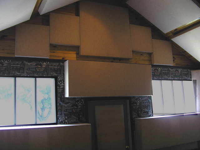 Rear Wall - This picture shows an absorption module at the top flanked by 4 diffusors, A large diffusor at the center and at the lower left and right (These are at ear level). The door at the center has an absorption module.