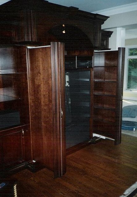 Custom A/V wall unit - Example of our custom work. Cherry in Jacobean brown stain, with hand glazed antiquing. Pullout video/DVD storage illustrated.
Features: Programmable light dimmers, whisper fans set on thermostat attached to plenum for ventilation of A/V components.