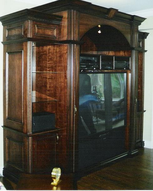 Custom A/V wall unit - Example of our custom work. Cherry in Jacobean brown stain, with hand glazed antiquing.
Features: Programmable light dimmers, whisper fans set on thermostat attached to plenum for ventilation of A/V components
