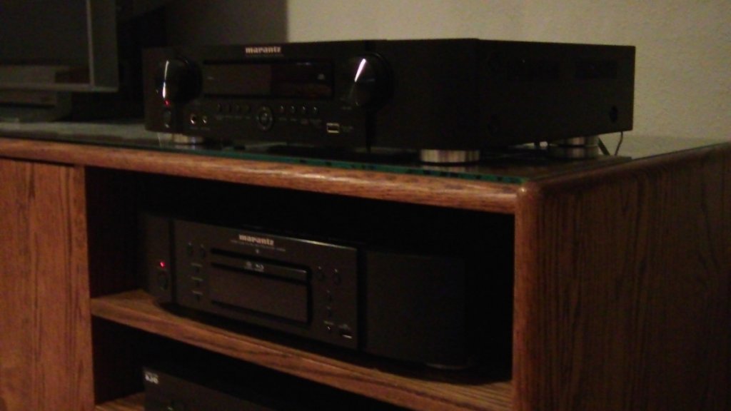 The AV side: 
The A/V stack on the right side of the TV: It consists of a Marantz NR1602 7.1 channel receiver, Marantz UD5005 uni. Blu-ray player. and a Dish 211 HD sat box. Behind the doors on this side lives my old Sony VCR and Panasonic DVD recorder. Speakers on the AV side of things are a/d/s/ HT 400LCR's in front, a/d/s/ HT300's in back, and two Velodyne DLS4000R subs in the rear corners of the room, crossed over at 60 Hz.