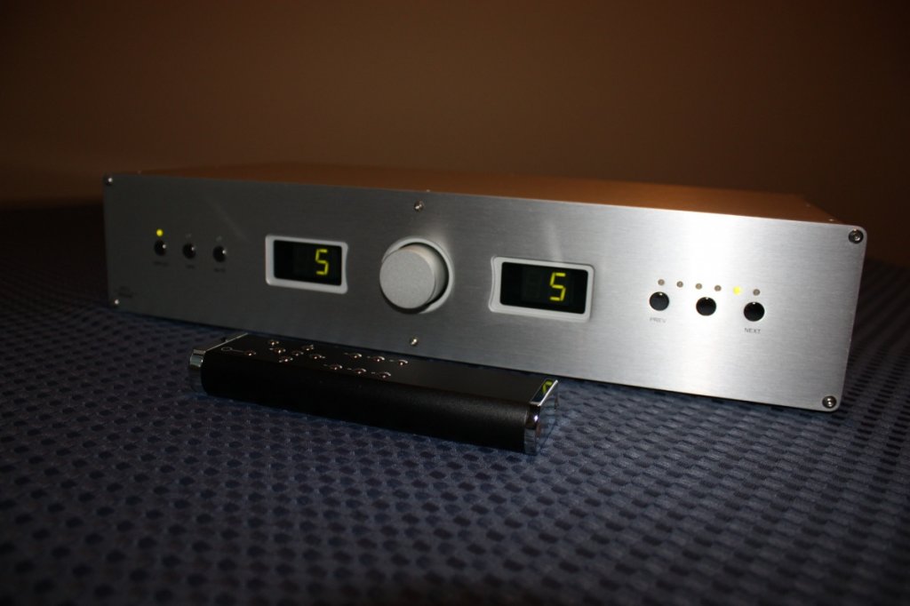 Unit powered on, and completely silent! Bent all metal remote in foreground.
