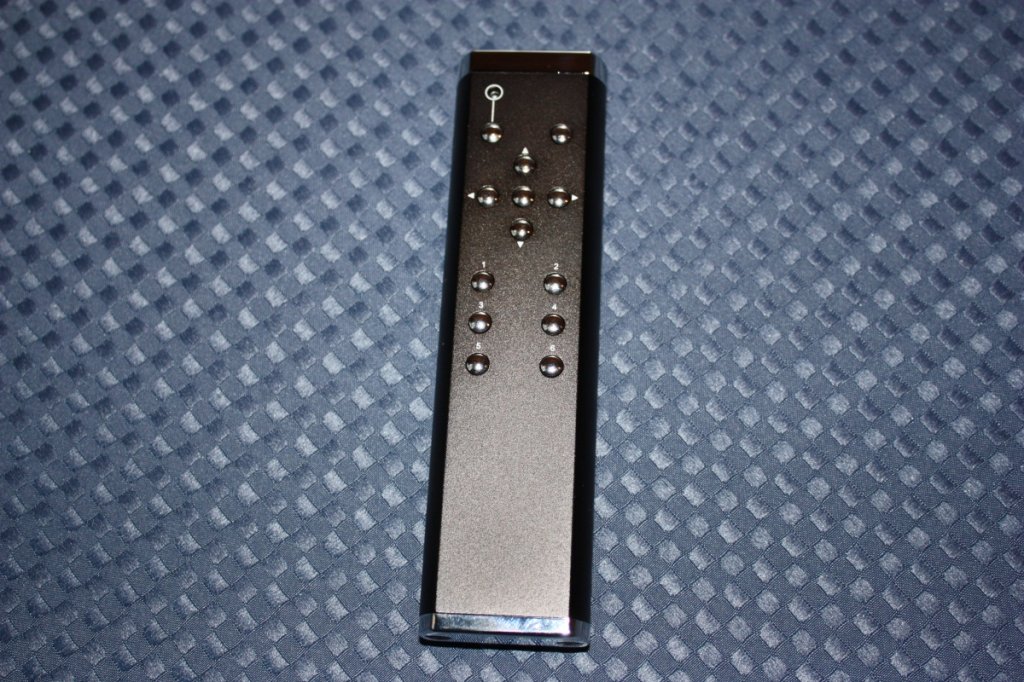 Bent all metal remote. Probably the finest remote from a DIY perspective. Balance control, Mute, Volume, 6 input selection, Tape Input and Power button (left upper hand corner). 61 steps of attenuation with extreme quality relays, and a maximum of 7dB of gain.